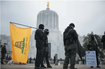 ??  ?? Armed members of the Boogaloo Bois in front of the Oregon State Capitol during a nationwide protest called by far-right groups in support of President Trump and his claim of electoral fraud in the 2020 presidenti­al election, Salem, January 17, 2021