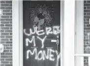  ?? TIMOTHYD. EASLEY/AP ?? Graffiti is seen on a door of the home of Senate Majority Leader Mitch McConnell on Saturday in Louisville, Kentucky.