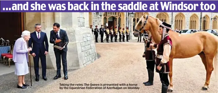  ?? ?? Taking the reins: The Queen is presented with a horse by the Equestrian Federation of Azerbaijan on Monday