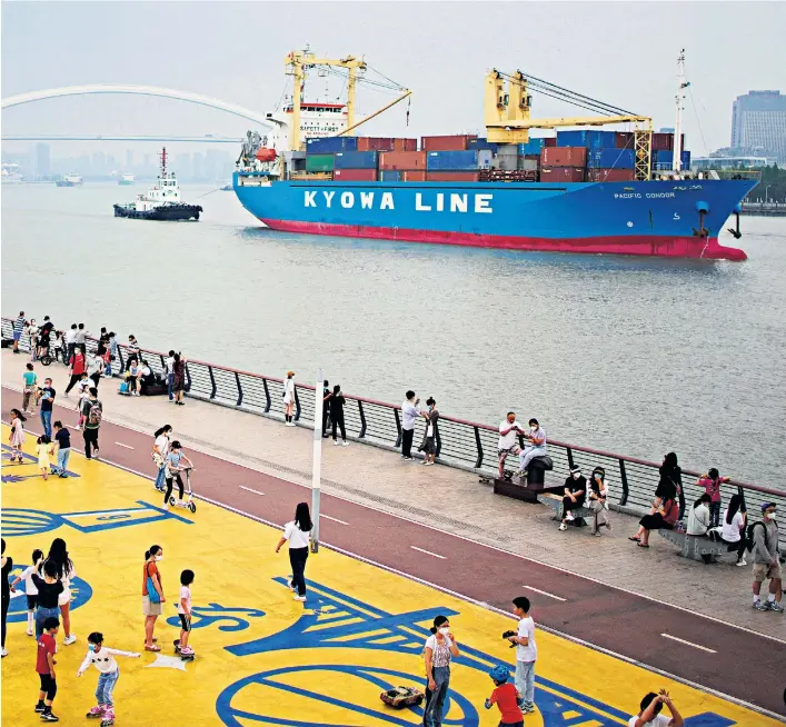  ?? ?? Free at last: Shanghai residents enjoy the end to lockdown. Below left, a Covid clean-up. Below right, Xi Jinping