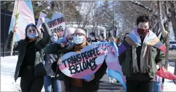  ?? PHOTO/STEPHEN GROVES
AP ?? Advocates for transgende­r people march from the South Dakota governor’s mansion to the Capitol in Pierre, S.D., on March 11, 2021, to protest a proposed ban on transgende­r girls and women from female sports leagues.