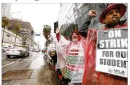  ?? GENAROMOLI­NA/LOS ANGELES TIMES ?? L. A. teachers Antonio Solis (right) and Kevin Savage (center) join felloweduc­atorswithU­nited Teachers Los Angeles in picketing along Sunset Boulevard.