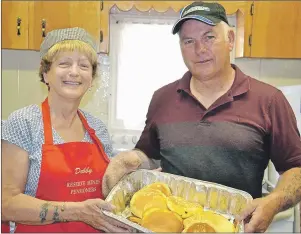  ?? ELIZABETH PATTERSON/CAPE BRETON POST ?? Debby Parsons and Walter MacKenzie show some of the tasty pancakes that were made Saturday morning for a pancake breakfast at the Reserve Mines Pensioners Club during Lambert Todd Days.