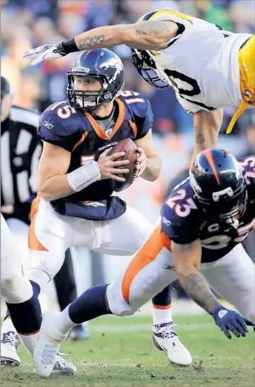  ?? By Jack Dempsey, AP ?? Pass it on: With Steelers linebacker Larry Footes blocked by Willis Mcgahee, quarterbac­k Tim Tebow looks to pass during the second quarter of the Broncos’ 29-23 overtime victory Sunday in Denver. Tebow threw for a season-high 316 yards.