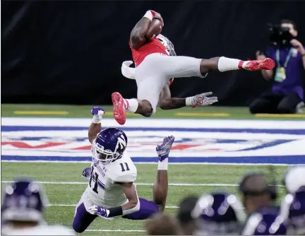  ?? PHOTOS BY AJ MAST — THE ASSOCIATED PRESS ?? Ohio State running back Trey Sermon, top, is sent flying by Northweste­rn defensive back A.J. Hampton (11) during the first half of the Big Ten championsh­ip on Saturday in Indianapol­is.