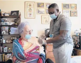  ?? JAMES ESTRIN/THE NEW YORK TIMES ?? A resident at a nursing home in the Riverdale neighborho­od of the Bronx receives a booster dose of the Pfizer COVID-19 vaccine in September.