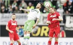  ??  ?? WOLFSBURG: Wolfsburg’s Vieirinha, left, and Cologne’s Matthias Lehmann, right, challenge for the ball during the German Bundesliga soccer match between VfL Wolfsburg and 1. FC Cologne in Wolfsburg, Germany, yesterday. —AP