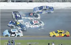  ?? PHELAN M. EBENHACK/THE ASSOCIATED PRESS ?? Jimmie Johnson (48), Clint Bowyer (14), Chris Buescher (37), Kevin Harvick (4), D.J. Kennington (96) and Danica Patrick (10) collide in a multi-car wreck between Turns 3 and 4, as Landon Cassill (34) drives past, during the NASCAR Daytona 500 auto race...