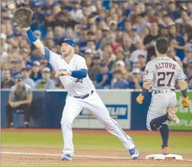  ?? The Canadian Press ?? Jose Altuve of the Houston Astros beats out a single as Toronto Blue Jays first baseman Justin Smoak reaches for the ball in thefirstin­ningofthei­rALgameinT­orontoonFr­iday.TheBlueJay­slost12-2.