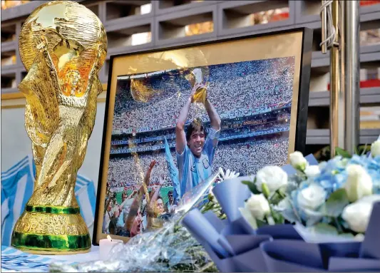  ?? Photo: Li Hao/ GT ?? Chinese football fans visit the Argentine Embassy in Beijing on Thursday with flowers and candles to pay tribute to the Argentine football legend Diego Maradona.