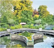  ??  ?? The Prince of Wales and Duchess of Cornwall, right, hold face masks at a reception for the Elephant Family Animal Ball at Clarence House yesterday. Above, the Lily Pool Garden at Highgrove