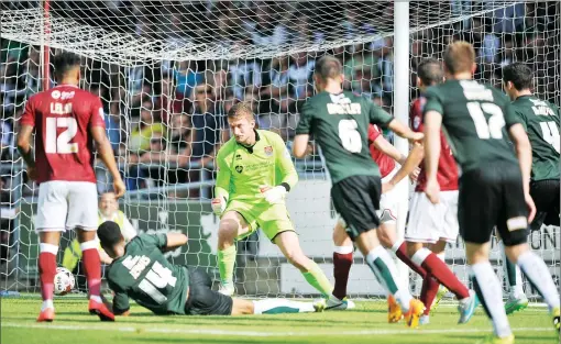  ?? PICTURES: Mike Capps ?? IN THE NET: Jake Jervis chips in Plymouth’s second