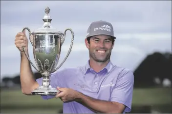  ?? ASSOCIATED PRESS ?? ROBERT STREB HOLDS THE TROPHY after winning a second hole playoff against Kevin Kisner at the RSM Classic golf tournament on Sunday in St. Simons Island, Ga.