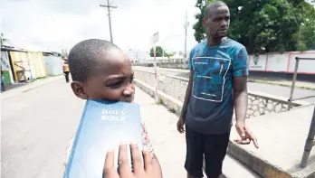  ?? RICARDO MAKYN/MULTIMEDIA PHOTO EDITOR ?? Tremayne Brown, the hero of Trench Town, talks to journalist­s about his September 8 rescue of Renaldo Reynolds from a flooded gully along Collie Smith Drive last week. The video of the dramatic rescue has gone viral over the last week.
