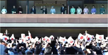  ??  ?? Akihito (fifth left), Michiko (sixth left) and members of the royal family extend New Year’s greetings to well-wishers at the Imperial Palace in Tokyo. — AFP photo