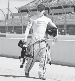  ?? BRYNN ANDERSON/ POOL PHOTO ?? Driver Austin Dillon walks to his car with his gear for the start of Sunday’s race at Darlington Raceway.