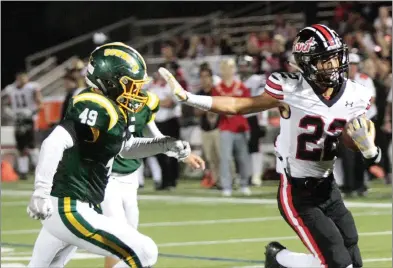  ?? Nikolas Samuels/The Signal ?? Hart’s Da’von Jones (22) avoids Canyon’s Trent Mears (49) as Jones scores a touchdown during the 50th game between the two at Canyon High School on Friday.