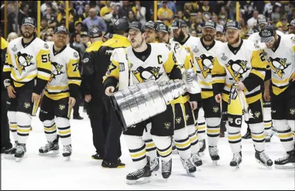  ?? AP PHOTO ?? If there are cracks in Pittsburgh’s armour, they came this off-season with the losses of goaltender Marc-Andre Fleury, defenceman Trevor Daley and forwards Nick Bonino, Chris Kunitz and Matt Cullen. But Sidney Crosby — shown holding the Stanley Cup —...