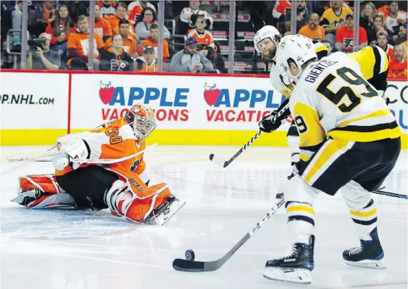  ?? TOM MIHALEK/THE ASSOCIATED PRESS ?? Philadelph­ia Flyers goalie Michal Neuvirth has no chance on one of Jake Guentzel’s four goals in Pittsburgh’s 8-5 Game 6 win Sunday, in Philadelph­ia.