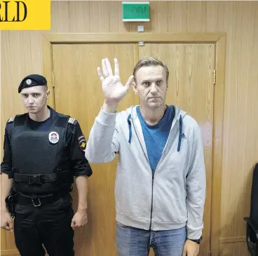  ?? PAVEL GOLOVKIN / THE ASSOCIATED PRESS ?? Russian opposition leader Alexei Navalny, shown here in a Moscow courtroom on Monday, has been sentenced to a month in jail for unsanction­ed protests held in January. This is the second 30-day jail term for Navalny this year.