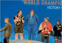  ??  ?? Laurel Hubbard, second left, stands on the podium after winning two silver medals at the world championsh­ips in California earlier this week.