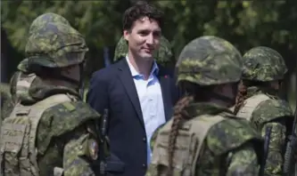  ?? ADRIAN WYLD, THE CANADIAN PRESS FILE PHOTO ?? Canadian Prime Minister Justin Trudeau reviews an honour guard, in this 2016 photograph, as they arrive at the Internatio­nal Peacekeepi­ng and Security Centre in Yavoriv, Ukraine.