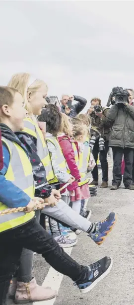  ??  ?? Prince William compares shoes with local nursery school children at Kirkwall Marina after opening a new hospital on Orkney