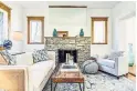  ??  ?? The living room features a hardwood floor and a wood-burning fireplace with stone surround and mirror above.