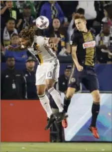  ?? CHRIS CARLSON — THE ASSOCIATED PRESS ?? LA Galaxy midfielder Jermaine Jonesdurin­g, left, heads the ball away from Union defender Jack Elliott during the first half of what became a scoreless draw Saturday night in Carson, Calif.