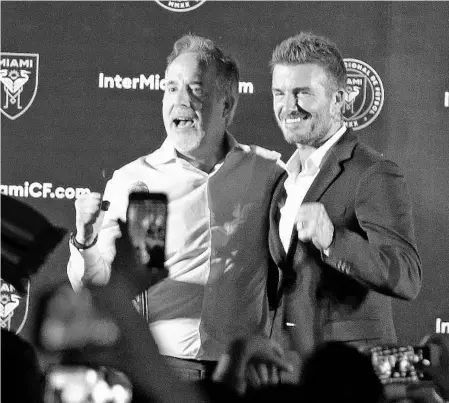  ?? CHARLES TRAINOR JR./AP ?? Jorge Mas, left, and David Beckham celebrate in Coral Gables after Miami voters gave city officials permission Tuesday to negotiate a no-bid lease deal with Beckham’s group, which wants to build a Major League Soccer complex on what has been a public golf course.