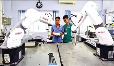  ??  ?? Technician­s use remote controls to operate machines at Saigon Hi-tech Park’s Training Centre in Ho Chi Minh City, Vietnam.