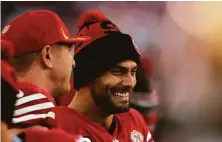  ?? ?? 49ers offensive lineman Daniel Brunskill (left) and QB Jimmy Garoppolo smile with a big lead in the second half.