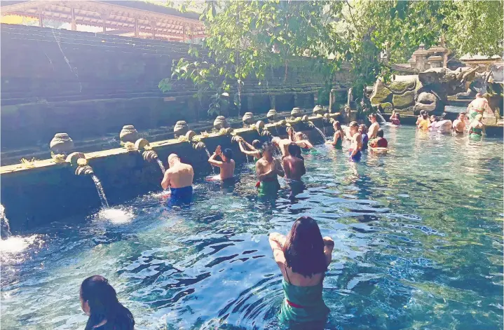  ?? ELAINE O’CONNOR ?? Pura Tirta Empul is a 960 AD temple. It’s stone petirtaan pool is used for purificati­ons.