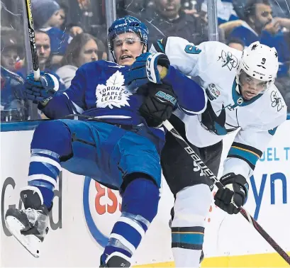  ?? NATHAN DENETTE THE CANADIAN PRESS ?? Leafs defenceman Jake Gardiner is taken into the boards by San Jose left winger Evander Kane during Wednesday’s game.