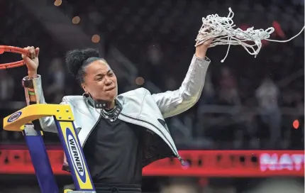  ?? KEN BLAZE/USA TODAY SPORTS ?? Head coach Dawn Staley cuts the net after her South Carolina Gamecocks team defeated the Iowa Hawkeyes on Sunday in the final of the Women’s NCAA Tournament.