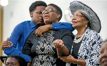 ?? AP ?? Grant Jean, 15, and his mother Allison Jean, who are the brother and mother of Botham Jean mourn with another churchgoer during a prayer service for Jean at the Dallas West Church of Christ.