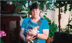  ?? —AFP ?? BYALA SLATINA, Bulgaria: Bulgarian nurse Valia Chervenias­hka holds a kitten in the yard of her house.