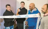  ?? CITY OF HARTFORD ?? Story and Soil co-owner Michael Mccoy cuts the ribbon on the newly renovated coffee shop as Mayor Arunan Arulampala­m, co-owner Michael Acosta and building owner Aaron Gill look on.