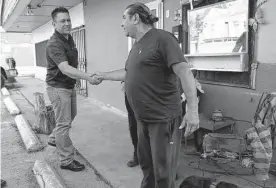  ?? Jerry Lara/staff photograph­er ?? Ignacio Elizondo, right, thanks CASA worker Paul Trujillo for his help. Elizondo was struggling with the care of his dogs and got help through CASA.