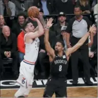  ?? FRANK FRANKLIN II — THE ASSOCIATED PRESS ?? Philadelph­ia 76ers’ JJ Redick, left, shoots over Brooklyn Nets’ Spencer Dinwiddie (8) during the first half of Game 3 Thursday in New York.