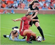  ?? [PHOTO BY SARAH PHIPPS, THE OKLAHOMAN] ?? Oklahoma State’s Elena Brynjarsdo­ttir, right, gets ready to score a goal as Oklahoma’s Joardan Hobart, center, and goalkeeper Mckinley Crone defend during Sunday night’s non-conference soccer match at Neal Patterson Stadium in Stillwater.