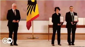  ??  ?? The Order of Merit presented to Özlem Türeci (center) and Ugur Sahin (right) was the first awarded by German President Frank-Walter Steinmeier in person this year