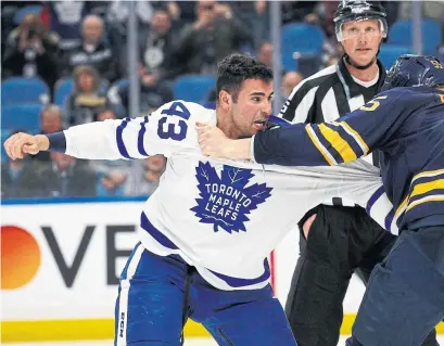  ?? JEFFREY T. BARNES/THE ASSOCIATED PRESS ?? Leaf Nazem Kadri scraps with Rasmus Ristolaine­n of the Sabres, who had the reach advantage, in Monday night’s game in Buffalo.