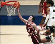  ?? (AP/Kathleen Batten) ?? Oklahoma guard Austin Reaves (Cedar Ridge) scored 28 points as the No. 12 Sooners defeated No. 14 West Virginia 91-90 in double overtime Saturday in Morgantown, W.Va.