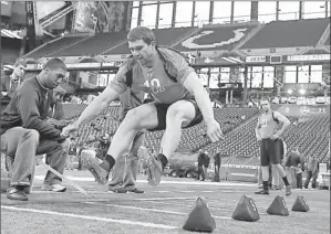  ?? By Brian Spurlock, US Presswire ?? Measuring up: Former Stanford quarterbac­k Andrew Luck, the possible top pick in April’s NFL draft, does a broad jump Sunday during the NFL scouting combine at Lucas Oil Stadium in Indianapol­is.