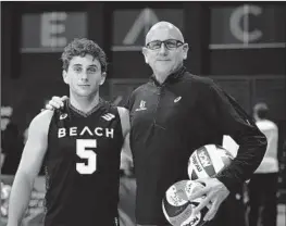  ?? John Fajardo Long Beach State Athletics ?? SETTER Aidan Knipe, left, a redshirt senior, stands next his father, Long Beach State volleyball coach Alan Knipe, after Alan earned his 400th career victory.