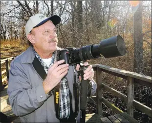  ?? (NWA Democrat-Gazette/Flip Putthoff) ?? Terry Stanfill photograph­s bald eagles Jan. 14, 2016, at SWEPCO Lake along the Eagle Watch Nature Trail near Gentry.