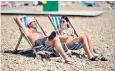  ??  ?? Sunbathers on the beach at Brighton