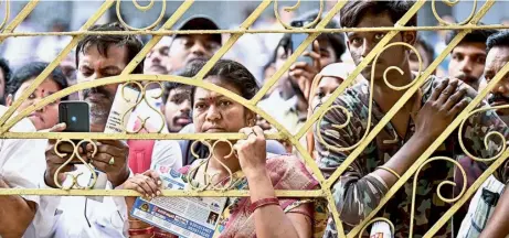  ?? K.V.S. GIRI ?? Anxious wait: Parents of candidates wait outside a centre in Vijayawada where the National Eligibilit­y-cum-Entrance Test for admission to the undergradu­ate medical programme is in progress on Sunday. This year, a record 23 lakh candidates registered for the test.