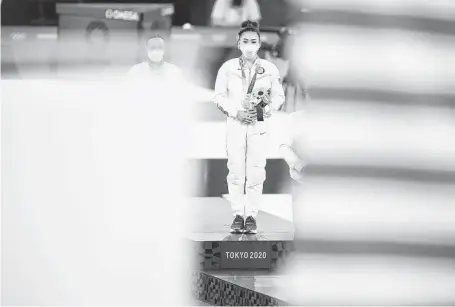  ?? Chang W. Lee / New York Times ?? Sunisa Lee takes center stage on July 29 during the medal ceremony following the women’s all-around gymnastics competitio­n.